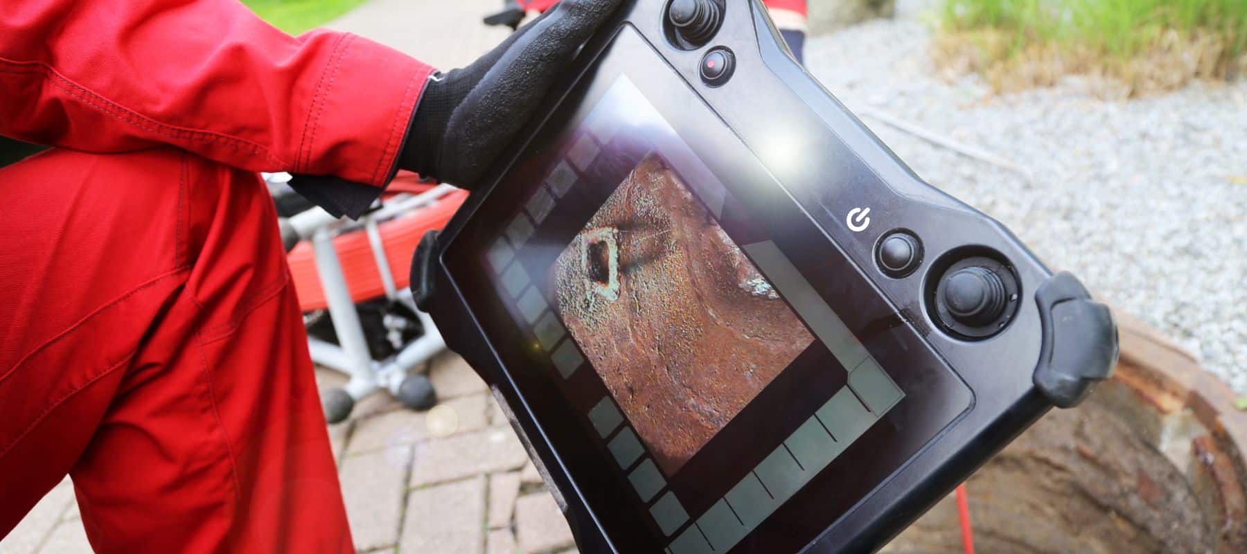 plumber looking at the live feed of a camera inspection